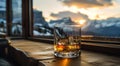 an empty glass of whisky and mountains