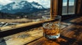 an empty glass of whisky and mountains