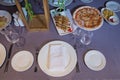 Tables set for meal . fork, knife , table towel . Pizza, potato fries. empty glasses and plates on the table in the restaurant Royalty Free Stock Photo