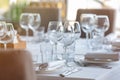 Empty glasses in restaurant background. Table set for an event party or wedding reception. Royalty Free Stock Photo