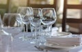 Empty glasses in restaurant background. Table set for an event party or wedding reception. Royalty Free Stock Photo