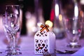 Romanian holiday decorations in restaurant. Empty glasses set with Romanian symbol of tricolor and bokeh background.