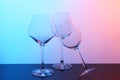 Empty glasses on table against color background Royalty Free Stock Photo