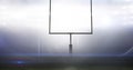 Empty goal post against illuminated bright american football sports field at night