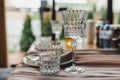 Empty goblet and goblet made of embossed transparent glass on the festive table.