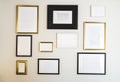 Empty gold and black photo and picture frames on white wall, mock up for your photos or text, copy space modern design luxury Royalty Free Stock Photo