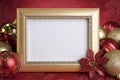 Empty Gold Frame with Christmas Ornaments on a red Background Royalty Free Stock Photo