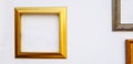 Empty gold, golden or yellow picture frame mock up on white concrete wall with copy space for add or fill text. Royalty Free Stock Photo