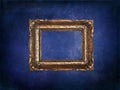 Empty golden frame on blue grunge wall Royalty Free Stock Photo