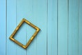An empty golden frame hangs askew on a plank wall Royalty Free Stock Photo
