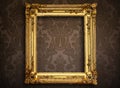 Empty golden frame on vintage wallpaper