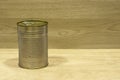 Empty golden metal tin can food on wood table Royalty Free Stock Photo