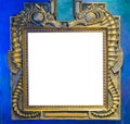 Empty golden painting or mirror frame decorated with seahorse animals to put what ever you want on the empty white space Royalty Free Stock Photo