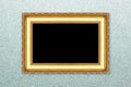 Empty golden vintage frame on wallpaper Royalty Free Stock Photo