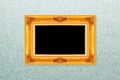Empty golden vintage frame on wallpaper Royalty Free Stock Photo