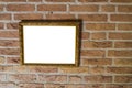 Empty golden vintage painting frame hanging on a brick wall background Royalty Free Stock Photo