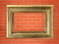 Empty golden wooden frame on the brick wall Royalty Free Stock Photo