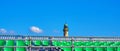 Empty grandstand on the Baltic Sea beach in WarnemÃÂ¼nde with a lighthouse as a panoramic background Royalty Free Stock Photo