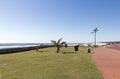 Grass Verge and Palm Trees Alogside Paved Promenade