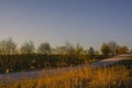 Empty gravel road in countryside with trees in surroundings at s