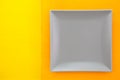 Empty gray ceramic dish on over orange and yellow background Royalty Free Stock Photo
