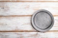 Empty gray ceramic plate on white wooden background. Top view, copy space Royalty Free Stock Photo