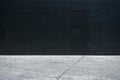 Empty gray floor with black modern building exterior.