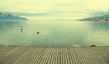 Empty gray wooden pier on Lake Geneva Royalty Free Stock Photo