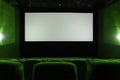 View on empty white cinema screen in green hall Royalty Free Stock Photo