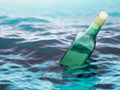 Empty green glass bottle in the sea Royalty Free Stock Photo