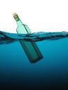 Empty green glass bottle in the sea Royalty Free Stock Photo