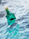 Empty green glass bottle in the sea Royalty Free Stock Photo