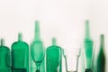 Empty green glass bottles and glasses stand in row Drink Concept Royalty Free Stock Photo