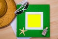 Empty green notebook on wooden table surface with beach hat, sea Royalty Free Stock Photo