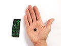 Empty green pill box and human palm with black pill, closeup Royalty Free Stock Photo