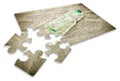 Empty green plastic bottle abandoned on the beach - concept image in jigsaw puzzle shape