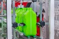 Empty green plastic jerry cans moving on conveyor belt at exhibition