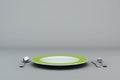 Empty Green Plate with fork, knife and spoon