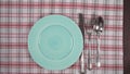 Abstract food background . Empty green plate with napkin, and cutlery.
