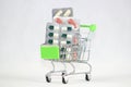 Green shopping cart with medicaments on an isolated white background. Royalty Free Stock Photo