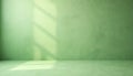 Empty green studio room with textured wall, floor surface. Bright sunlight creates window shadows across empty studio backdrop. Royalty Free Stock Photo