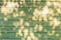 Empty green wathered old wooden table background texture with sunlight on surface Royalty Free Stock Photo