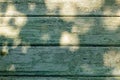 Empty green wathered old wooden table background texture with sunlight on surface Royalty Free Stock Photo