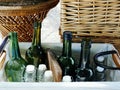 Empty green and White color glass bottles ready for bottling wine arranged in wicker baskets Royalty Free Stock Photo