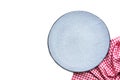 Empty grey ceramic plate and red folded tablecloth isolated on the white background. Royalty Free Stock Photo