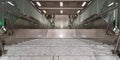 Empty grey marble staircase between floors of Frankfurt airport, leading down, with glass, metal and plastic. Symmetry Royalty Free Stock Photo