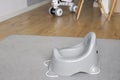 Empty grey potty in living room. baby potty. Potty training, copyspace Royalty Free Stock Photo