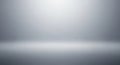 Empty grey studio background with a soft spotlight effect and subtle floor reflection for product display Keywords Royalty Free Stock Photo