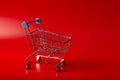 Empty Groceries trolley on red background Royalty Free Stock Photo