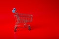 Empty Groceries trolley on red background Royalty Free Stock Photo